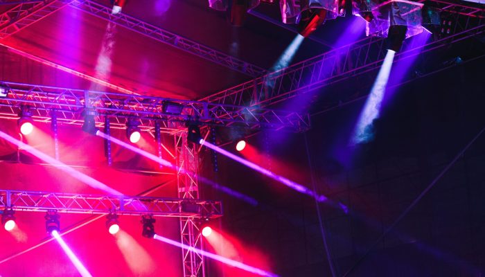 Spotlights, red and blue beams of lights above stage during concert event festival